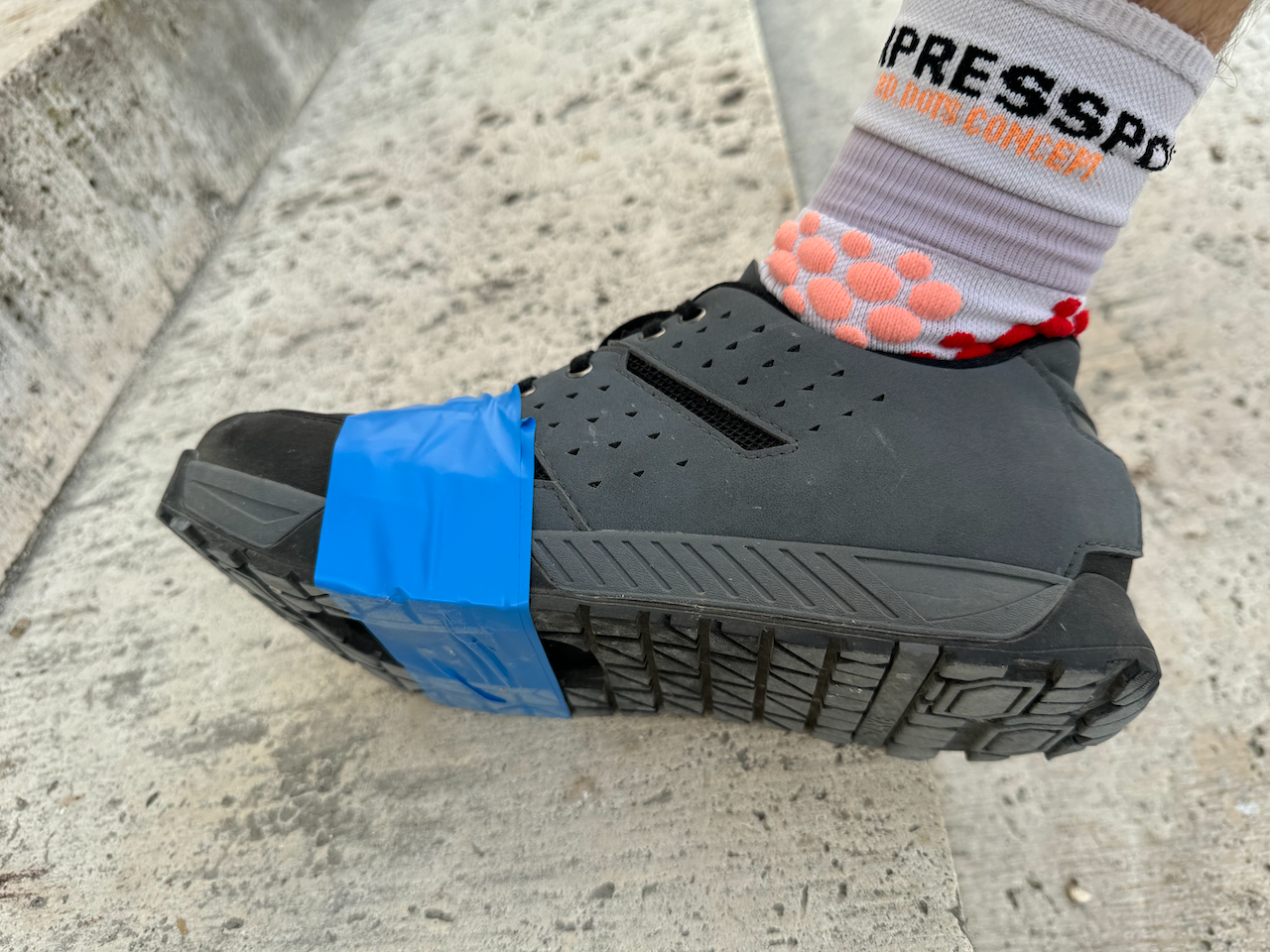 Taping over my cycling shoes at Chambord